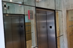 Mirror wrapped around elevator